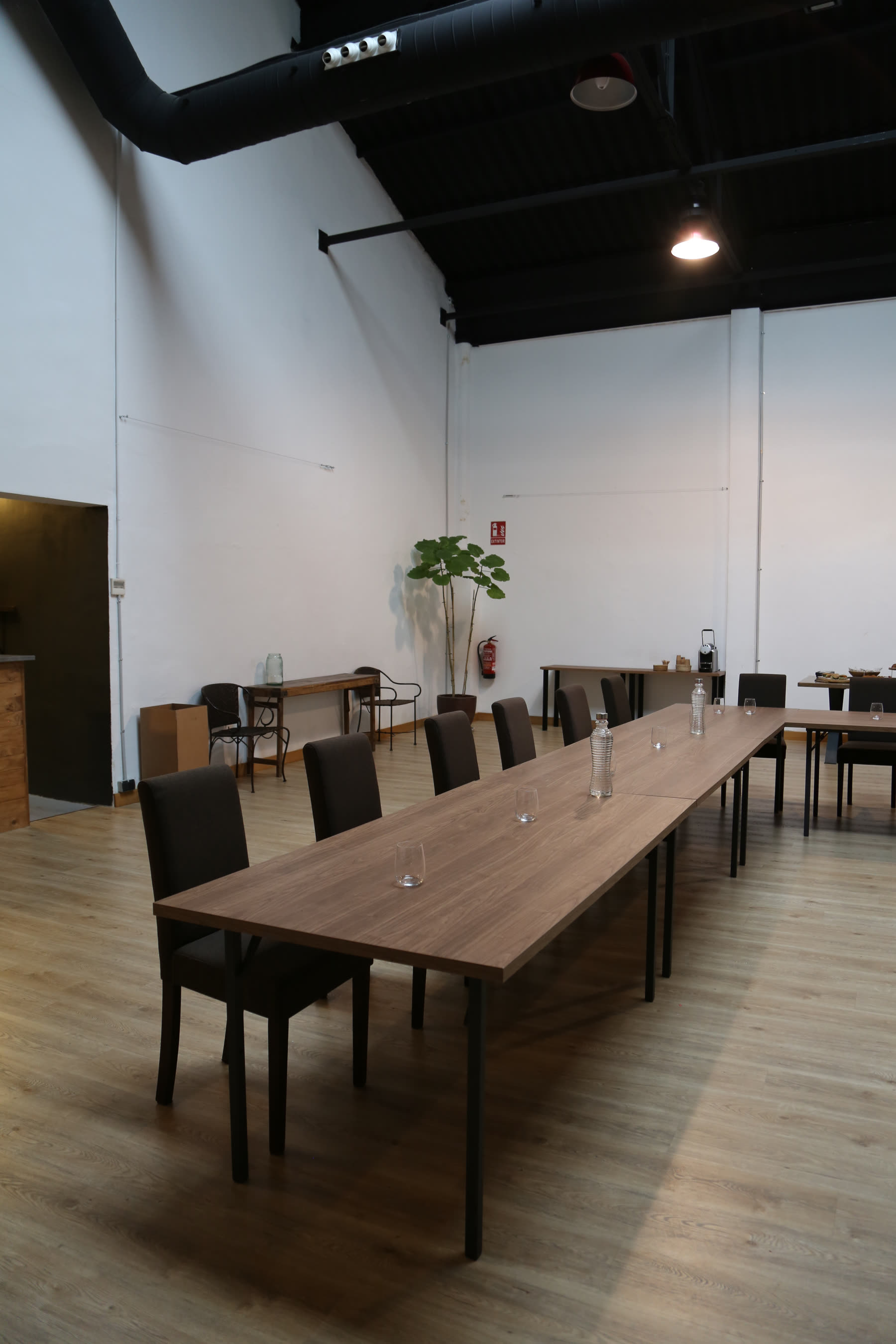 Mesa en U montada con plantas y luz natural en la sala principal